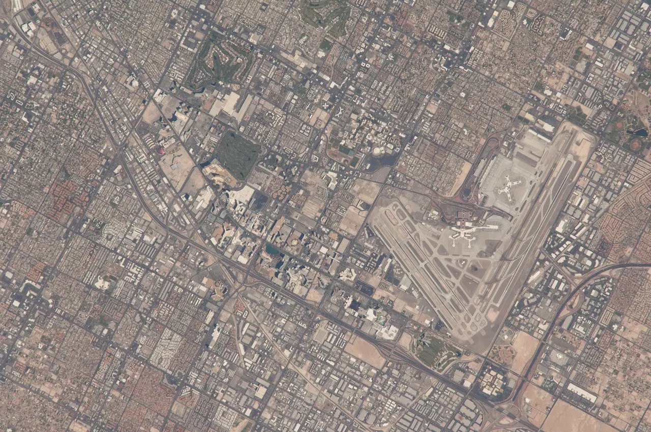 Astronaut photograph from the International Space Station of the Las Vegas valley with the airport runways at lower right