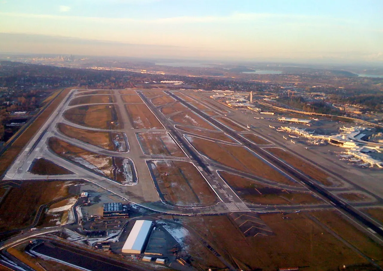 Aerial view of Seattle-Tacoma International Airport at dusk showing its three parallel runways