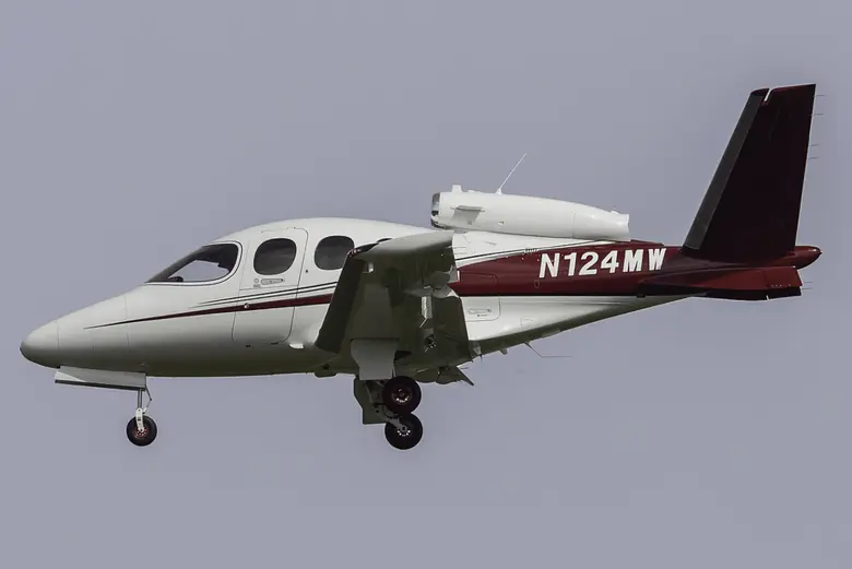 A Cirrus Vision Jet on approach with its landing gear down