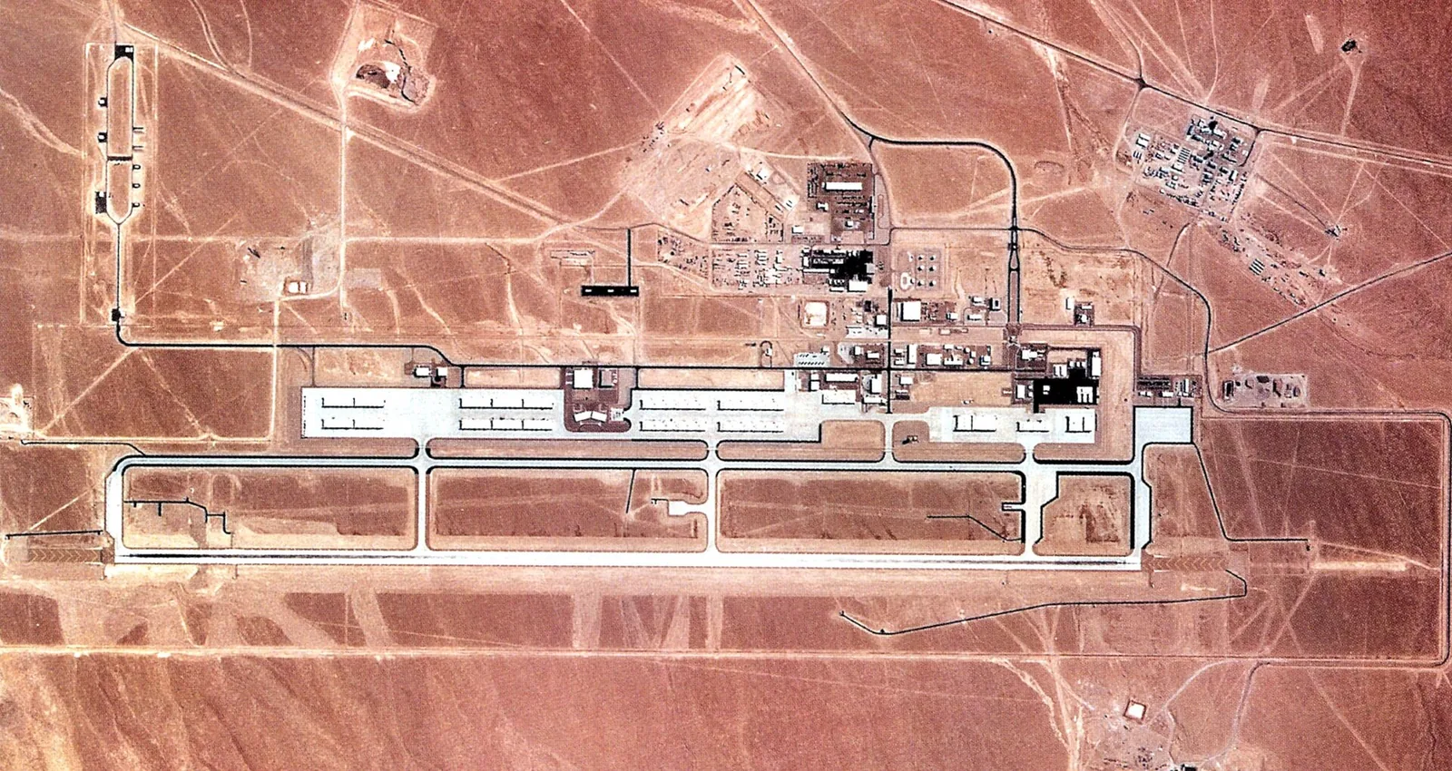 Aerial photograph from 1990 of Tonopah Test Range Airport in Nevada with its hangars and runway