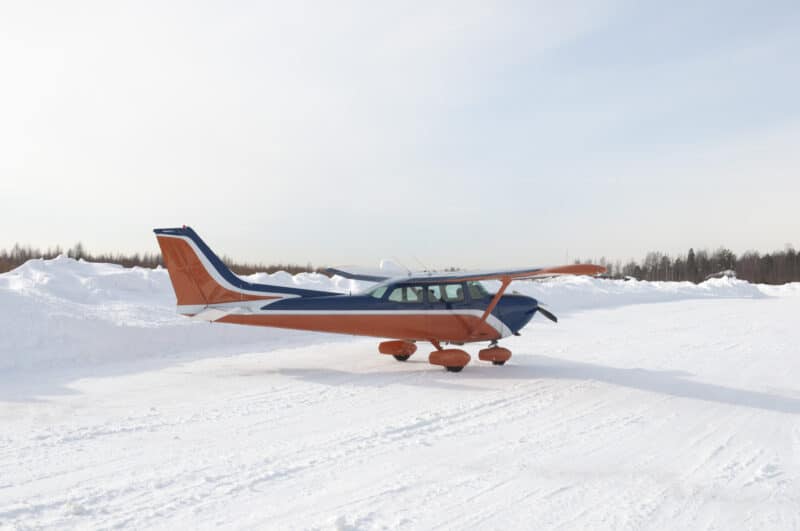 Light private aircraft on taxi during the snowy winter season