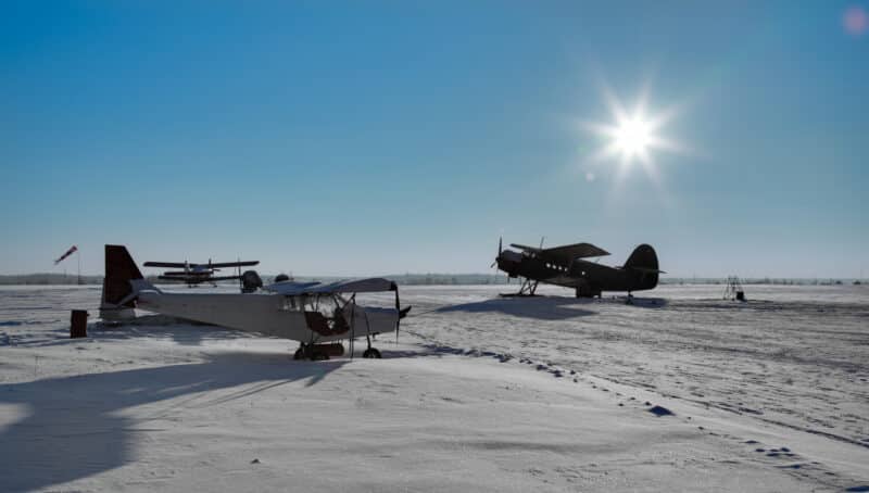 Small airfield with planes in the snow